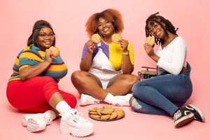 three black girls eating cookies